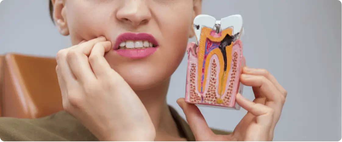 Woman experiencing tooth pain needing emergency dental care